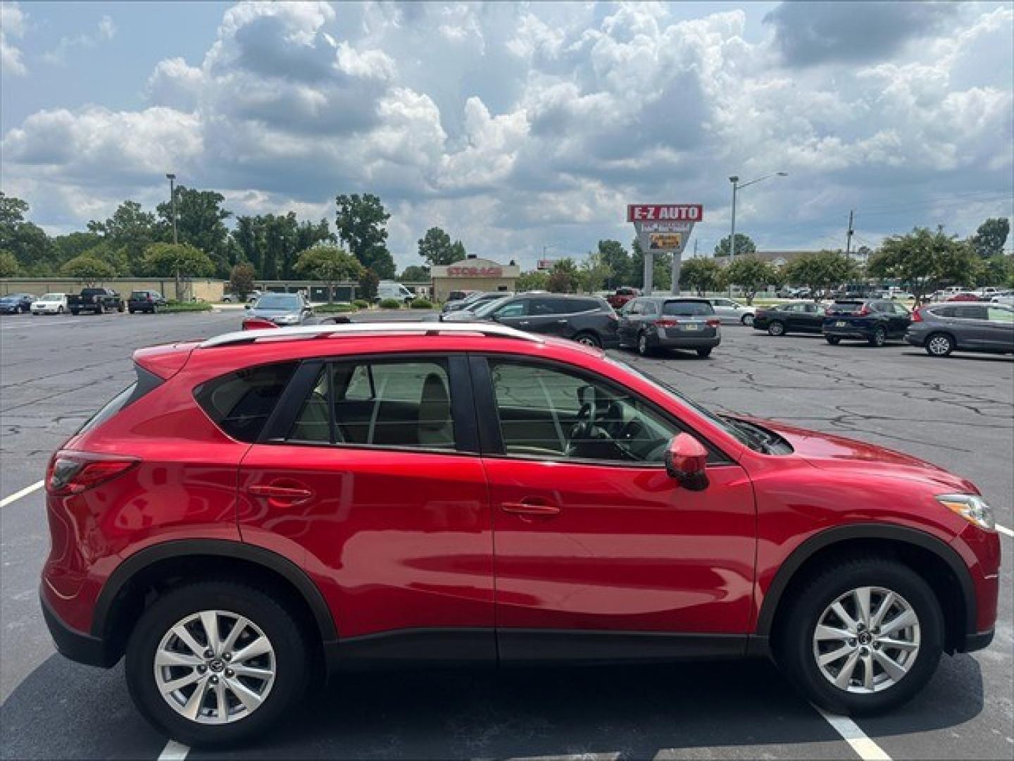 2015 Soul Red Mazda CX-5 Sport AT (JM3KE2BE0F0) , 6-Speed Automatic transmission, located at 3900 Bragg Blvd., Fayetteville, NC, 28303, (910) 868-3000, 35.081905, -78.943367 - T-10019 - 2015 Mazda CX-5 JM3KE2BE0F0457938- Photo#2